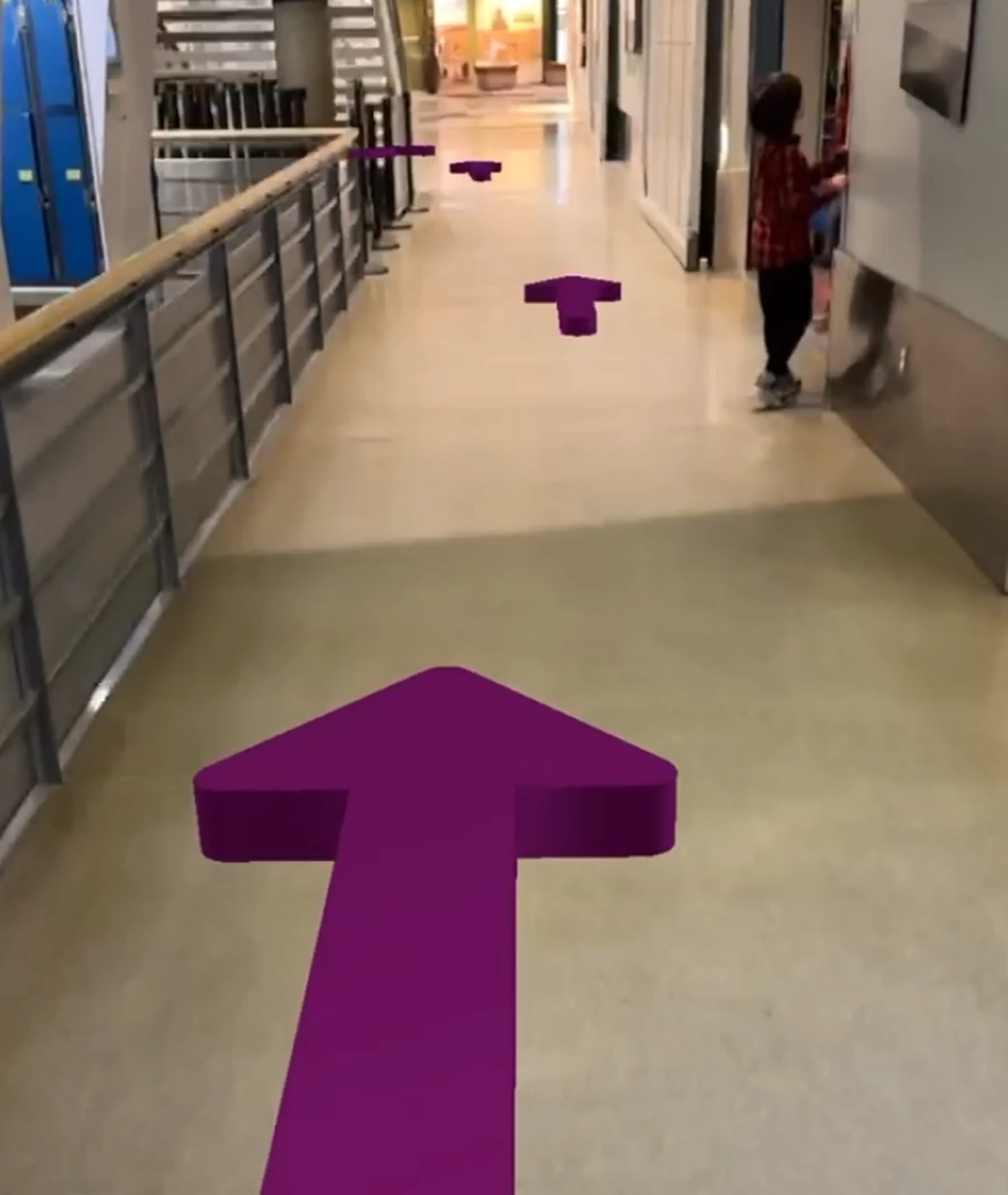 An AR view overlaying arrows on the exhibit hallway floor, guiding visitors to the Space Gallery.