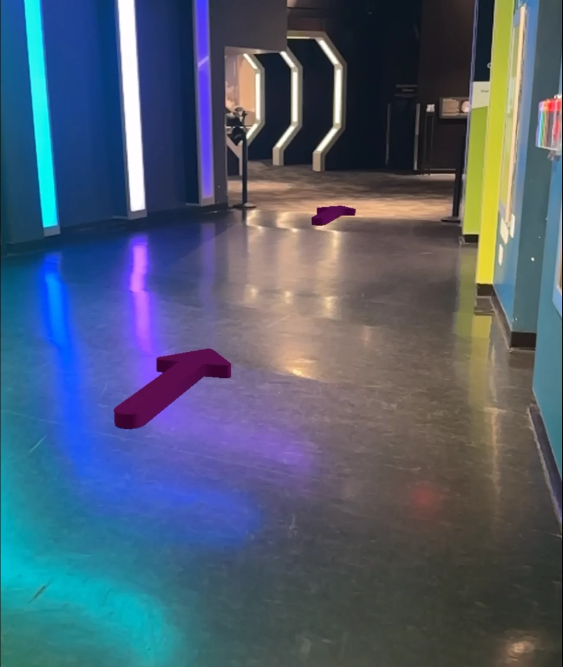 An AR view with a purple arrow pointing down a corridor toward the Space Gallery entrance.